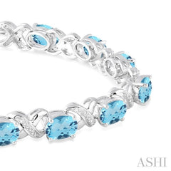 7x5 MM Oval Cut Blue Topaz and 1/20 Ctw Round Cut Diamond Fashion Bracelet in Sterling Silver