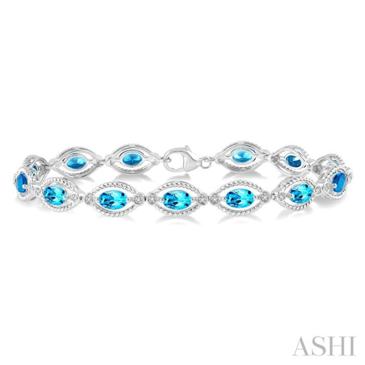 1/10 Ctw Round Cut Diamond & 6x4 MM Oval Cut Blue Topaz Semi Precious Bracelet in Sterling Silver